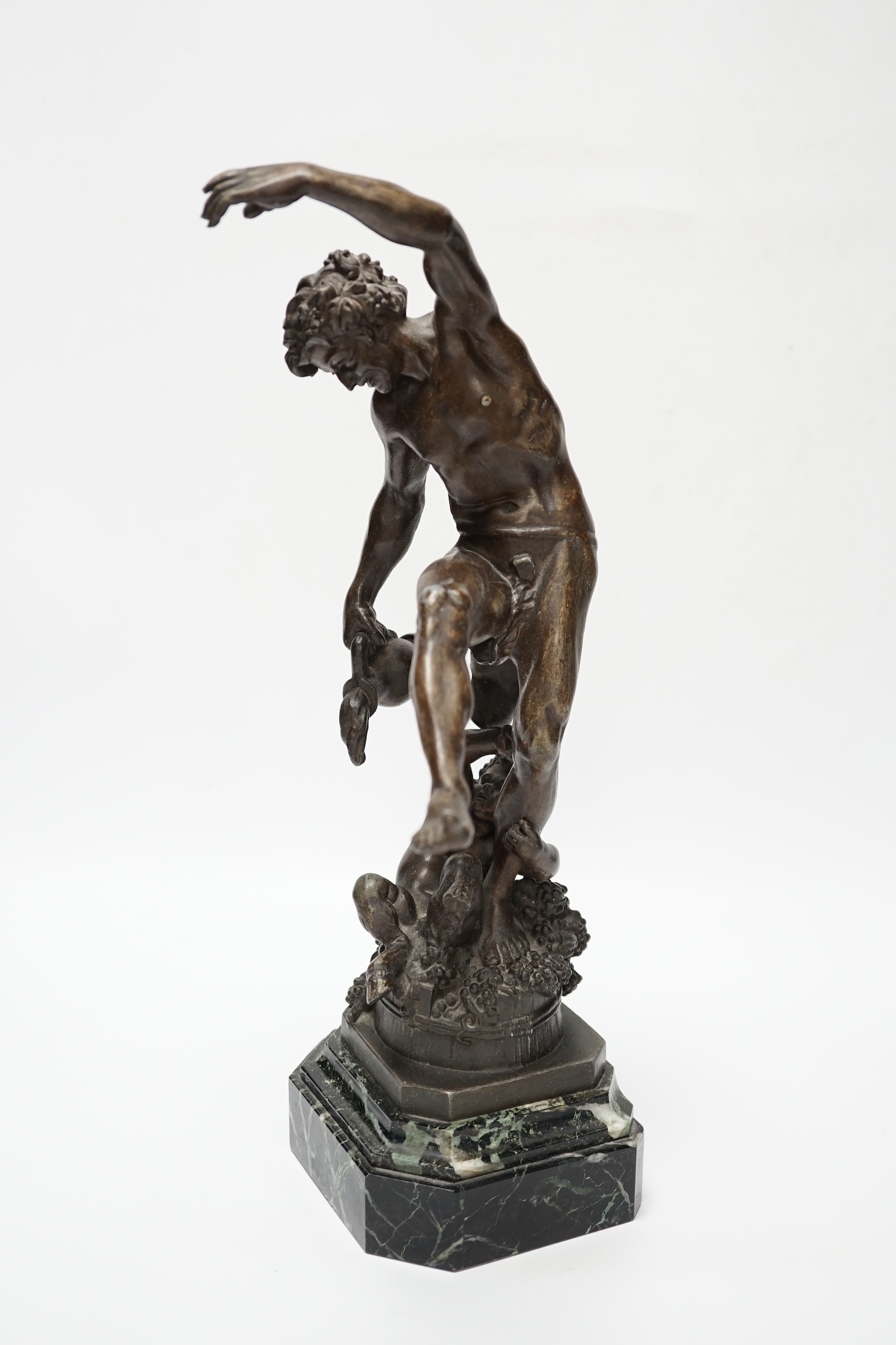 A bronzed spelter dancing figure of Bacchus - ‘Le Vin’, with a fawn and bunches of grapes, on a marble base, 36cm high